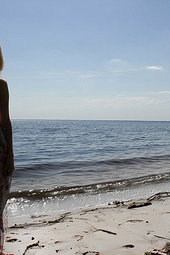 Nude girl is lonely at the beach